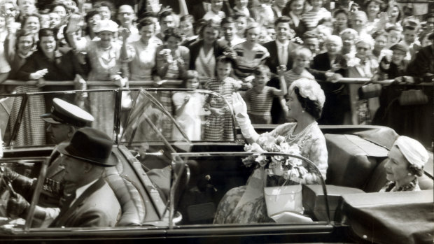 The Queen Mother waves to the crowd along St Kilda Road