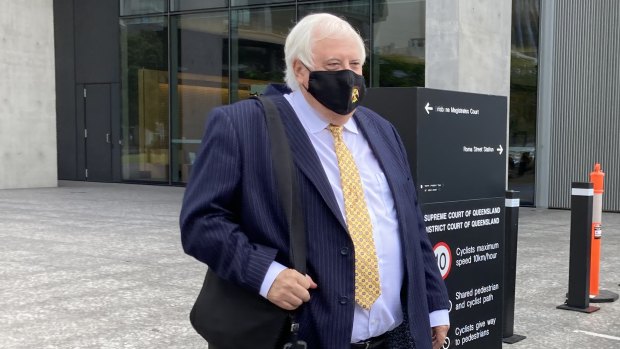Clive Palmer leaves Brisbane Supreme Court this week wearing a mask with the Southport Yacht Club logo.
