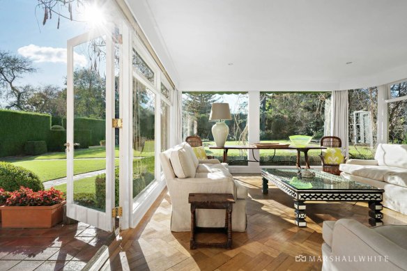 Living areas connect to terraces and lawns. 