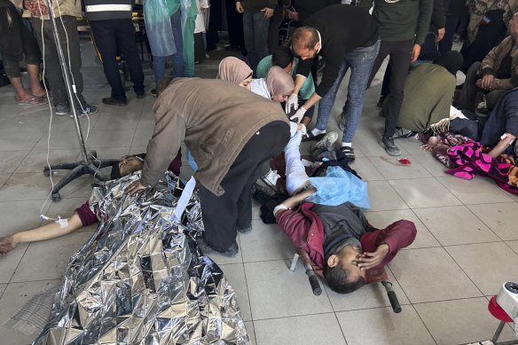 Palestinians wounded in an Israeli strike while waiting for humanitarian aid on the beach in Gaza City are treated in al-Shifa Hospital.