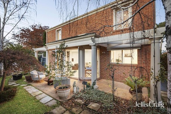 The paved back porch, surrounded by established trees and lush lawns, was one of the original, well-manicured drawing cards for buyers.