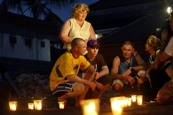 The Thompson family lays out candles at the sight of the Sari Club in 2012.