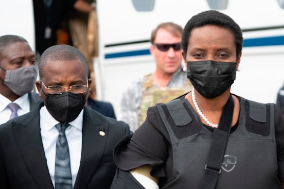 Haiti’s first lady Martine Moise, wearing a bullet proof vest and her right arm in a sling, arrives at the Toussaint Louverture International Airport, in Port-au-Prince, Haiti, Saturday, July 17, 2021. 