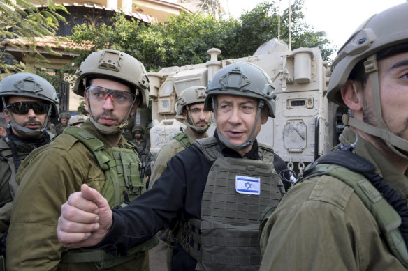 Israeli Prime Minister Benjamin Netanyahu receives a security briefing with commanders and soldiers in the northern Gaza Strip on Christmas Day.