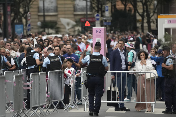 Spectators gather in Paris prior to the opening ceremony. (AP Photo/Christophe Ena)