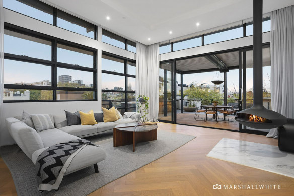 The statement fireplace is a focal point in the lounge room.