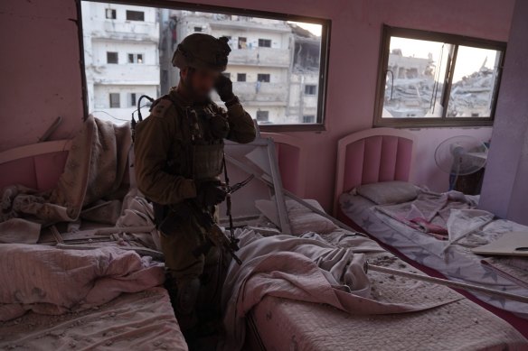 An Israeli soldier inside a children’s bedroom in northern Gaza where the IDF says it found weapons.