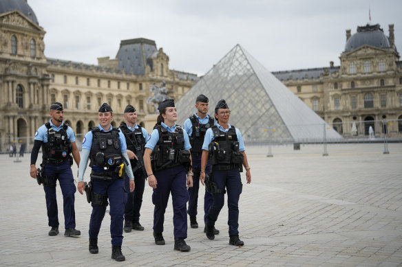 The streets of Paris are crowded with three levels of law-enforcement officers.