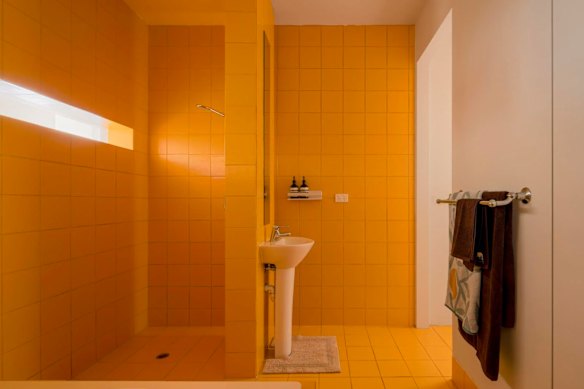 The egg-yolk yellow central bathroom, askew in its own box within the apartment’s expansive interior, was just one characterful element of the warehouse conversion.