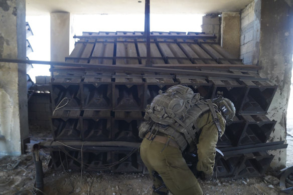 Israeli soldiers check a rocket launcher used by Hamas militants in the Gaza Strip.