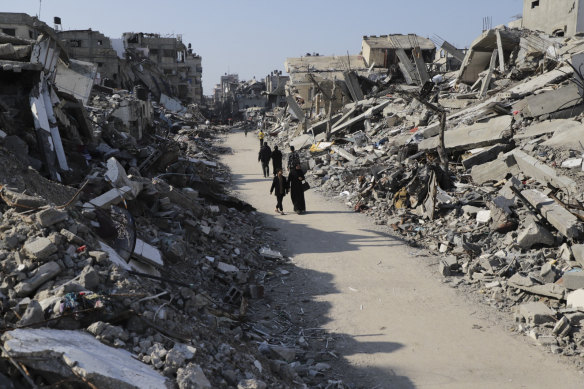 Palestinians walk through the destruction from the Israeli offensive in Jabaliya refugee camp in the Gaza Strip in February. Israel has struck the area again this week.