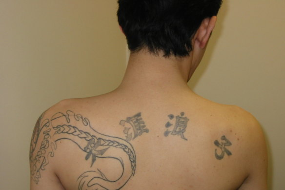 Chin Kwang Lee in custody in 2003 - "outside the law" tattoo.