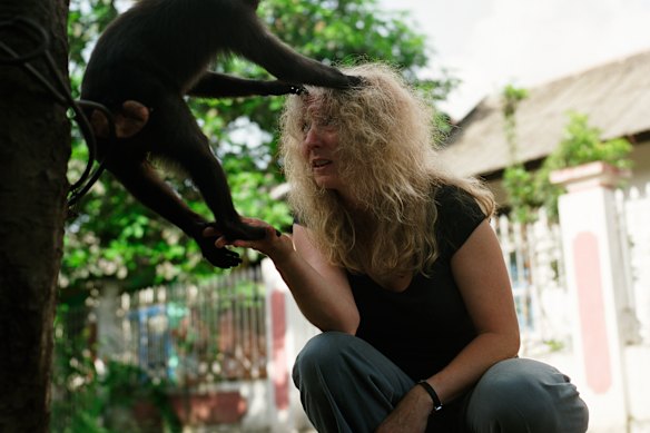 Lisa Jones-Engel with a monkey during field work.