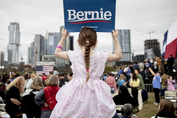 Lily Barbour, 5, holds up a campaign sign for Democratic presidential candidate Bernie Sanders.