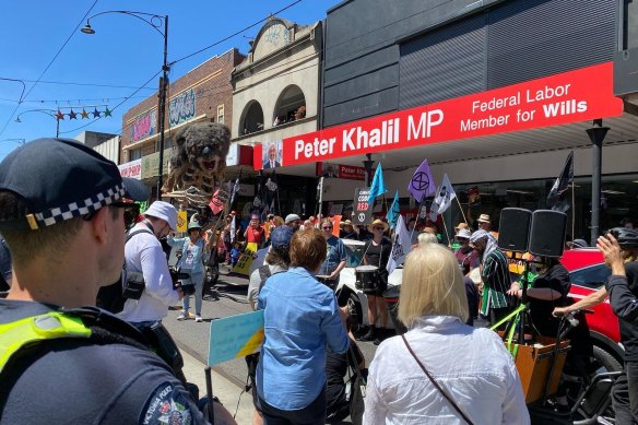 Climate activists, flanked by ‘Blinky’ the smoke-breathing Koala, gather outside Labor MP Peter Khalil’s office in Melbourne’s north.