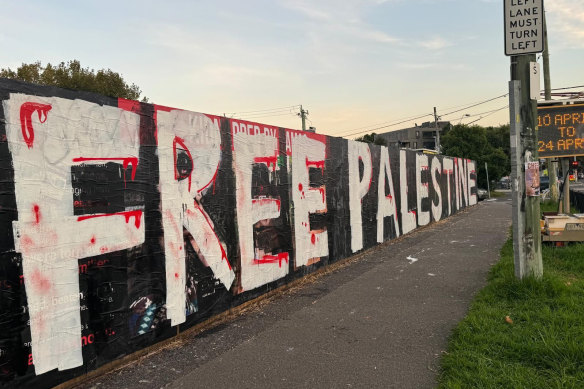 The freshly painted sign conceals a tribute to Israeli hostages that was created in the heart of Melbourne’s Jewish community.