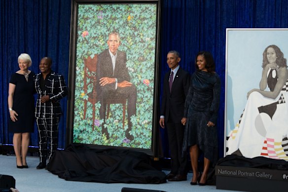 Kim Sajet, left, with artist Kehinde Wiley, former president Barack Obama and former first lady Michelle Obama, during the unveiling of their portraits in 2018.