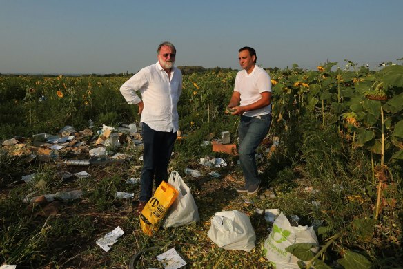 Paul McGeough (left) amid the wreckage of MH17 on the outskirts of Rassypnoye in eastern Ukraine.