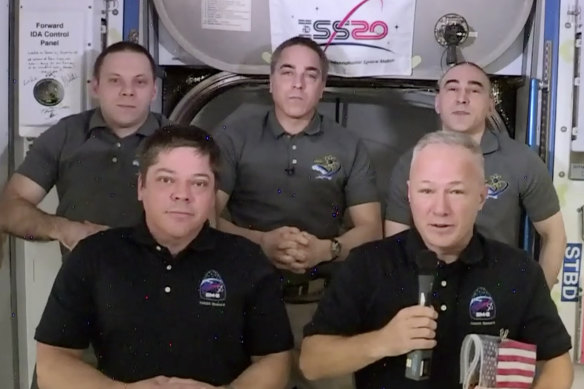 This photo provided by NASA shows astronauts Bob Behnken (front left) and Doug Hurley (front right) during an interview on the International Space Station on Saturday, August 1, before their return to Earth.