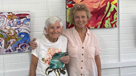 99-year-old Brisbane-based artist Anne Collins poses with friend Kathy Sullivan in Art Space Toowong, the community art hub she co-founded in 1989. 