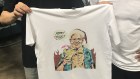 Printers in Marrickville hold up a T-shirt lampooning Scott Morrison.