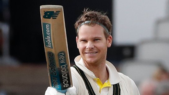 Australia's Steve Smith raises his bat after scoring 200 runs.