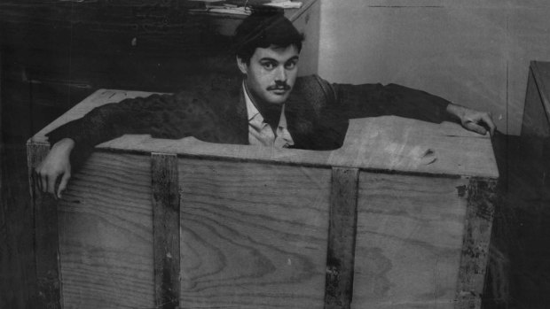 A policeman shows one of the crates used in the daring airline robbery attempt.
