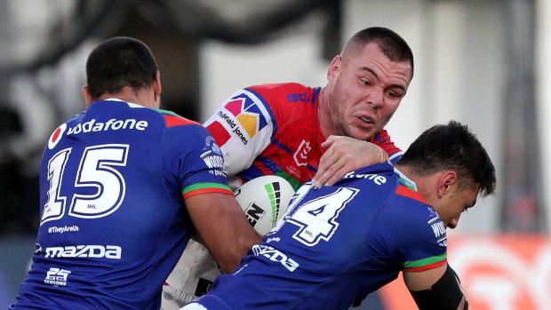 Damaging: David Klemmer (centre) makes a hit-up during Newcastle's victory over the Warriors in Auckland.