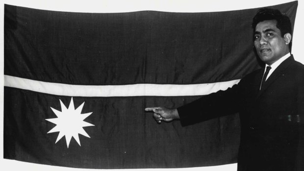 Theodore Moses, an officer at the Republic of Nauru's Melbourne office, unveils the Nauruan National flag on February 2, 1968.