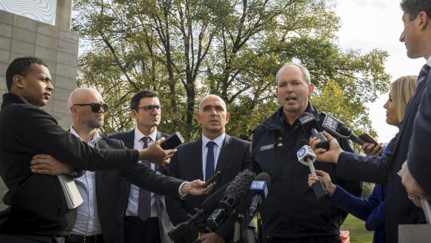 The MCC's Stuart Fox, AFL's Travis Auld and Victoria Police Commander Tim Hansen hold a press conference to address the recent violence at AFL matches.