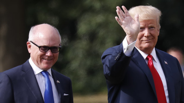 US President Donald Trump leaves Winfield House, residence of the US Ambassador Woody Johnson, left, during his visit to the UK in  July.