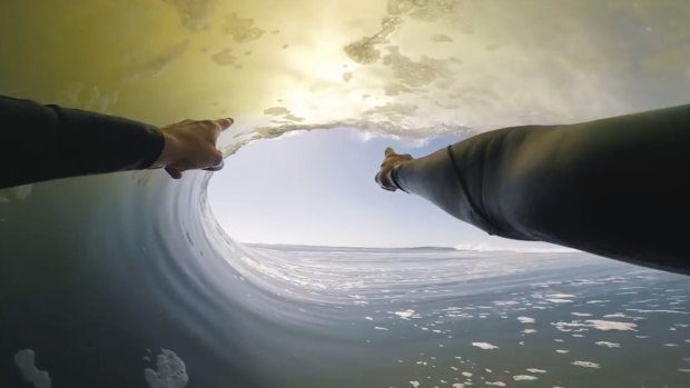 Ride of his life: In this image made from video provided by Chris Rogers, surfer Koa Smith points at a wave during his two-minute ride off the coast of Namibia.