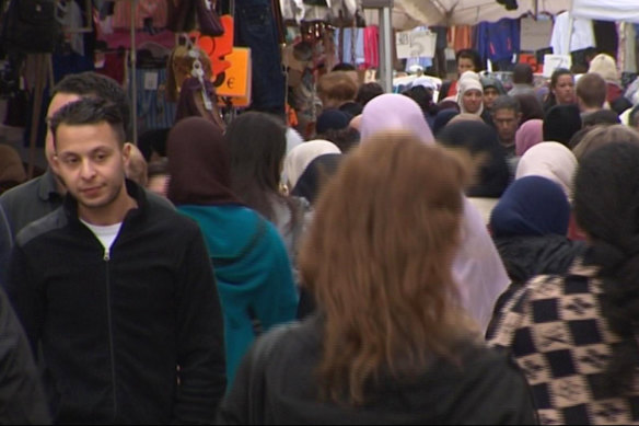 Salah Abdeslam, left, walking through a market in Brussels in 2016, was one of 20 people on trial for the 2015 Paris attacks.