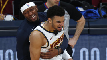 Jamal Murray is hugged by teammate Torrey Craig after making a key basket late in game two.