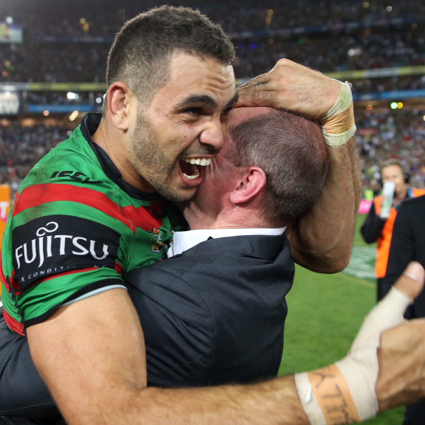 Greg Inglis and Michael Maguire share a moment after South Sydney’s 2014 grand final triumph.