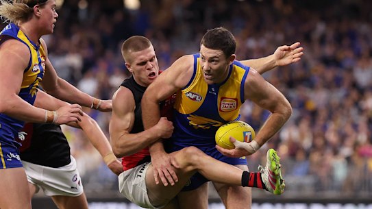 Jeremy McGovern of the Eagles gets tackled by Ben Hobbs.