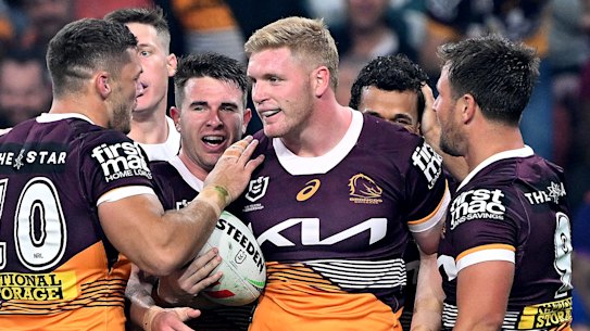 Brisbane players celebaret Tom Flegler’s try against Melbourne.