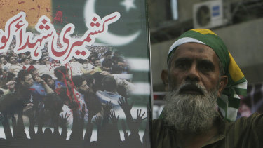 A Pakistani holds a placard that reads, "salute to Kashmiri martyrs," during an anti-Indian protest in Karachi, Pakistan.