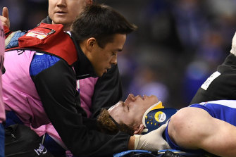 Concussion crisis: North Melbourne's Ben Brown is treated for concussion during a match in 2017.