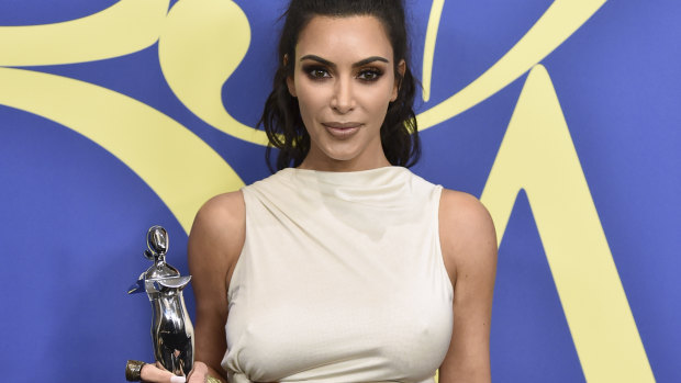 Kim Kardashian West poses in the winner's walk with the Influencer award at the CFDA Fashion Awards.
