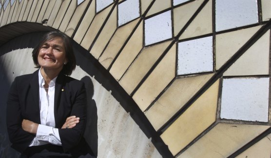 Sydney opera house chief executive Louise Herron against some of the tiles that adorn the side of the sails.