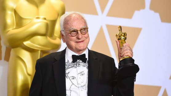 James Ivory, wearing a shirt featuring the face of star Timothée Chalamet, with the Oscar he won for best adapted screenplay for Call Me by Your Name in 2018.