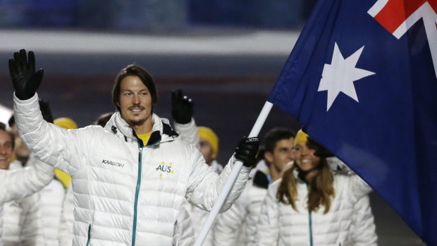 Pullin carries the flag as he leads his team during the opening ceremony of the 2014 Winter Olympics in Sochi, Russia.