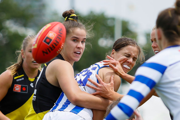 Richmond’s Ellie McKenzie tackles North Melbourne’s Jasmine Garner.