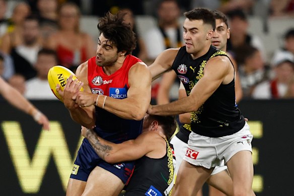 Christian Petracca of the Demons is tackled by Rhyan Mansell of the Tigers.