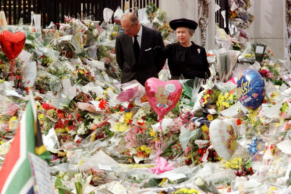 The Queen and Duke of Edinburgh look at the mass of floral tributes laid outside Buckingham Palace in memory of  Diana after her death in 1997. 
