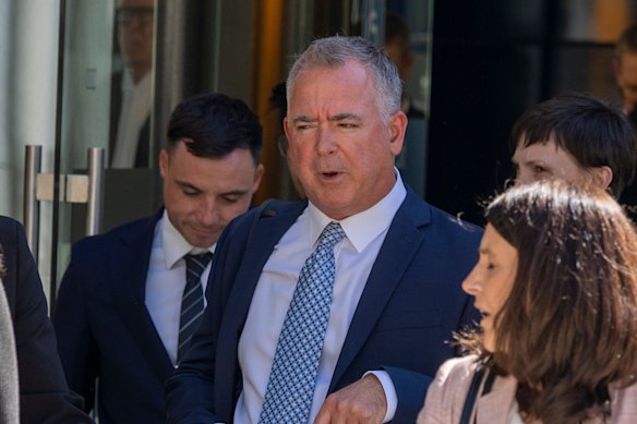 Coles manager of health products Matthew Hankin (light blue tie), outside federal court on Thursday after appearing a witness in the case brought by the ACCC.