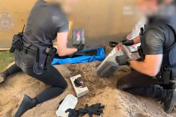 Police making the discovery of a cocaine haul underneath a concrete slab.
