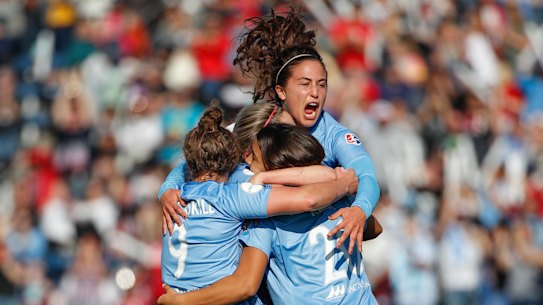 Sam Kerr is mobbed by her Chicago teammates after scoring against Portland.