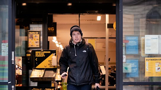 Life goes on: a customer exits a supermarket in Copenhagen, Denmark. 